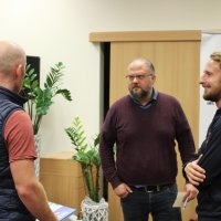 Rozmowa dwóch uczestników spotkania z zaproszonym gościem.