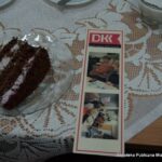 Na zdjęciu widać kawałek tortu na talerzyku oraz zakładkę do książki przygotowaną specjalnie z okazji obchodzonej rocznicy.