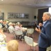 Podróżnik stojący pomiędzy widownią opowiada o swojej podróży