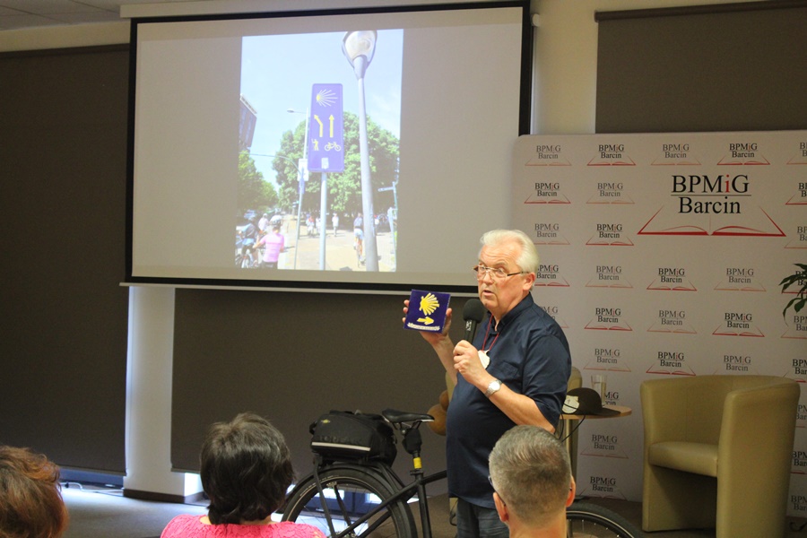 Prelegent podczas opowieści o podróży prezentuje symbol którym oznaczany jest szlak pielgrzymki